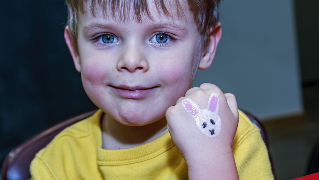 Kid with a bunny painted on his hand