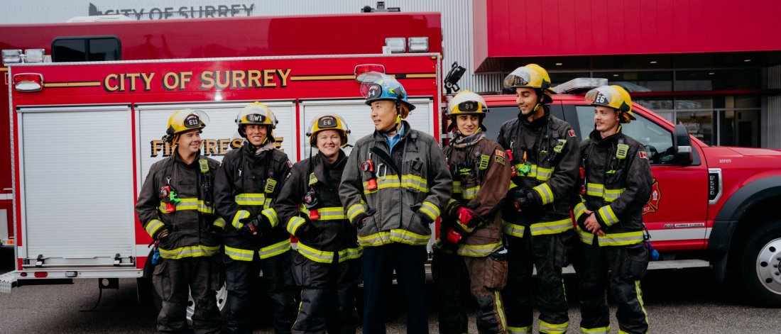firefighters standing in front of fire truck