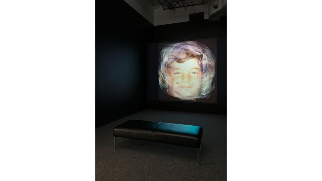 a young man's face on a video screen