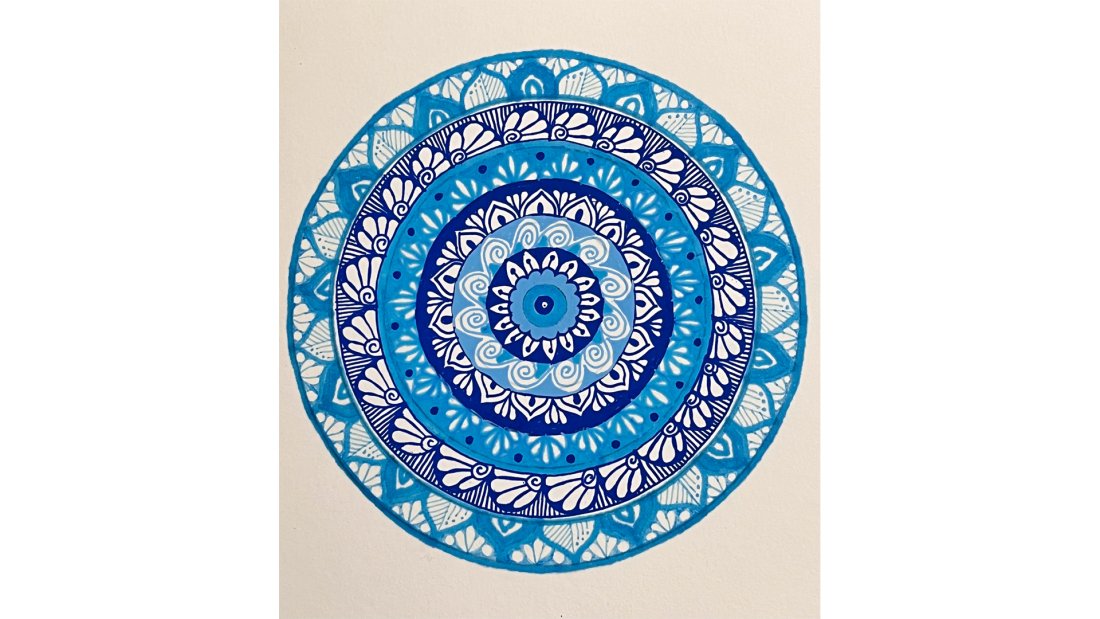 A mandala made with various blue inks.