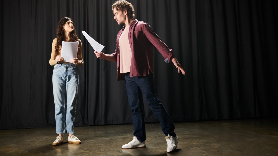 Man and woman reading a theatrical script.