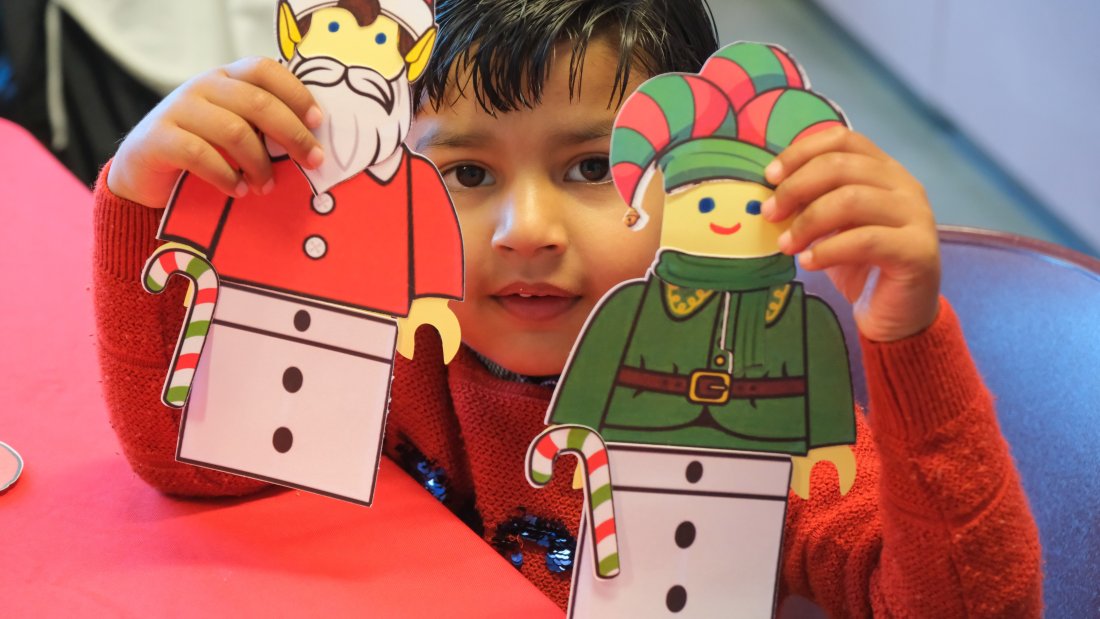 kid holding crafts