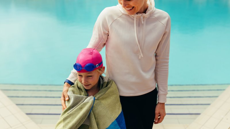 a parent and child with a towel