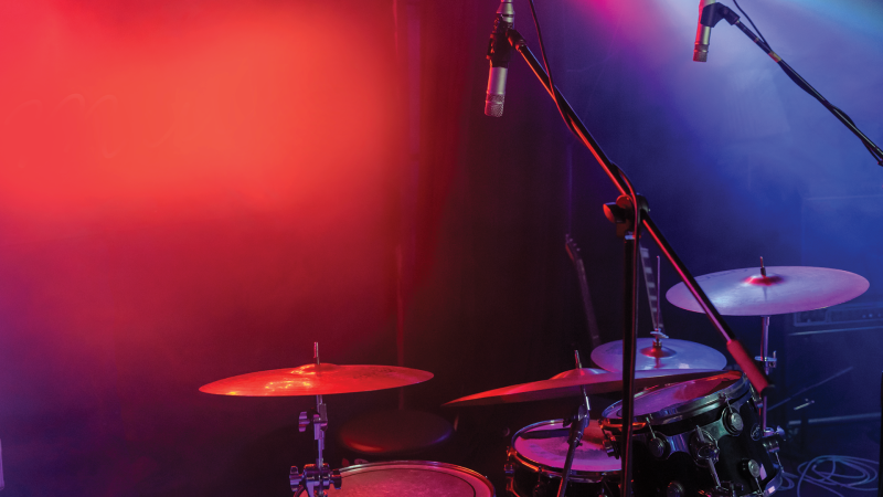 A drum kit in a red and purple background