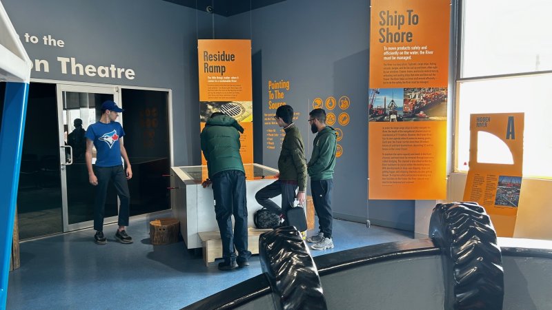 Four kids looking at a museum exhibit.