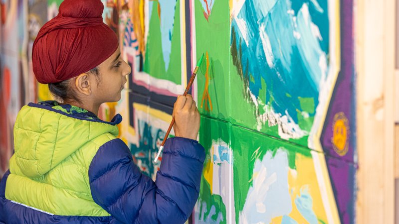 A child painting a wall.