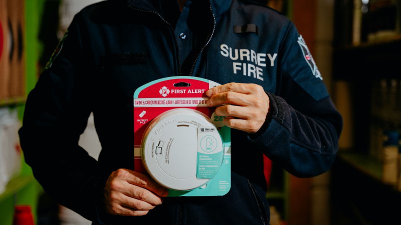 Staff holding smoke alarm