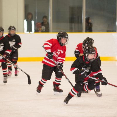 Children playing hockey. 