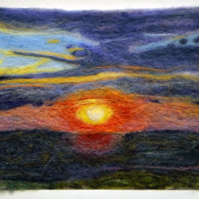 a felted picture of a pink-orange-yellow sunset over dark water with a blue and yellow sky above