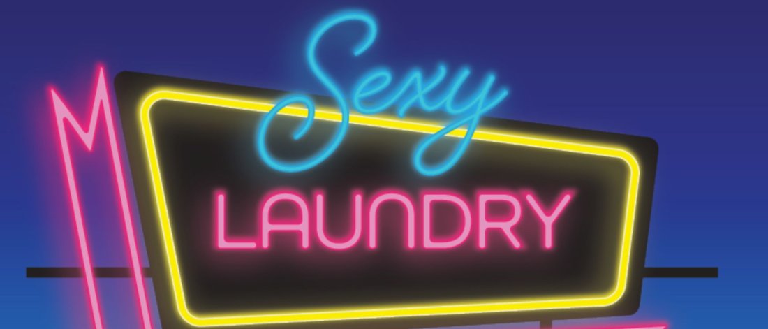 Neon sign against a blue night sky that says Sexy Laundry