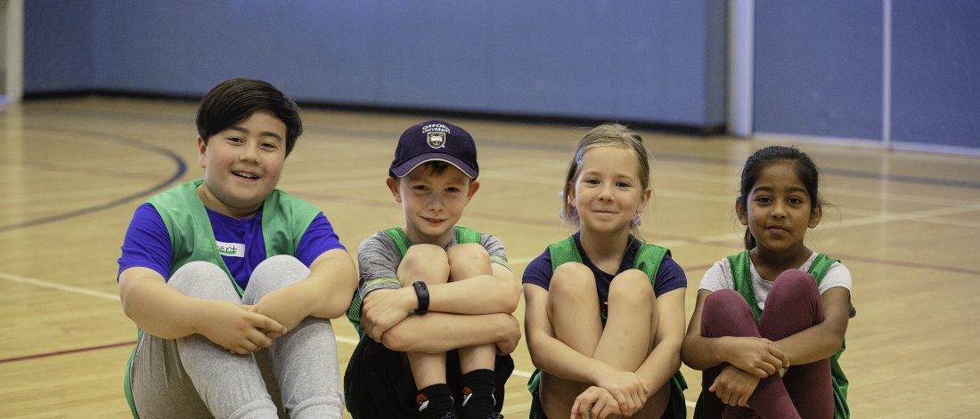Children sitting in the gymnasium. 