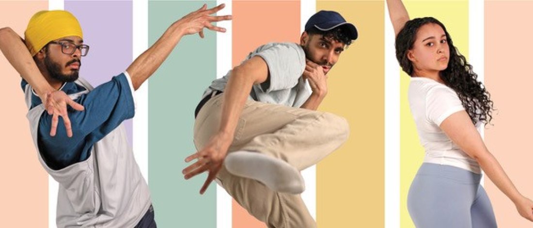 Action shot of the three dancers against a stripy pastel coloured background