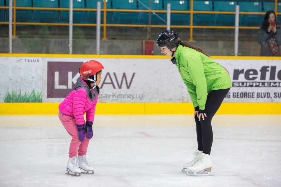 A skating instructor and participant.