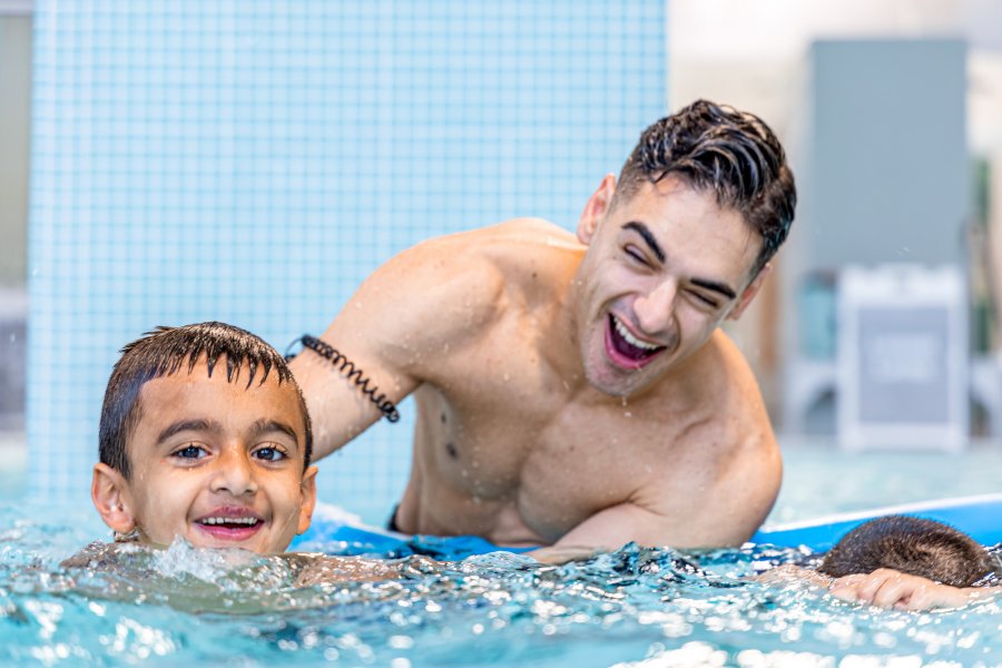 swim instructor and boy swimming