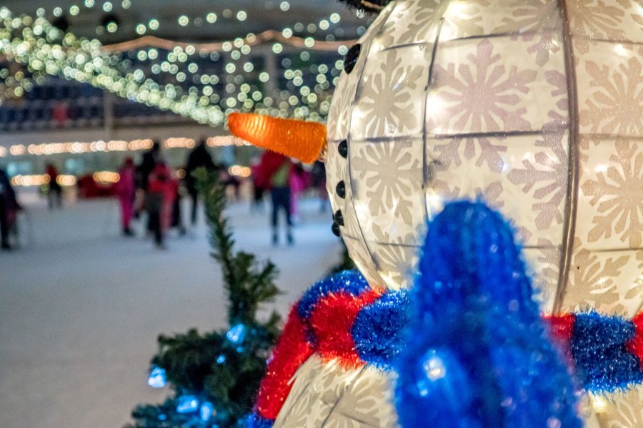 a snowman shining as people skate